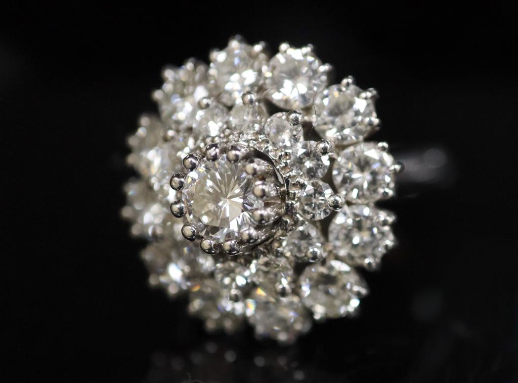 A modern 14ct white gold and diamond cluster ring,